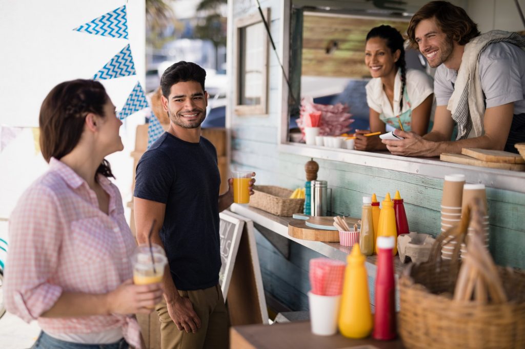 Couple interacting with each other at food truck van